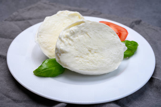 istock Cheese collection, soft white Italian mozzarella di bufala campana with fresh green basil leaves and red tomatoes 1198117468