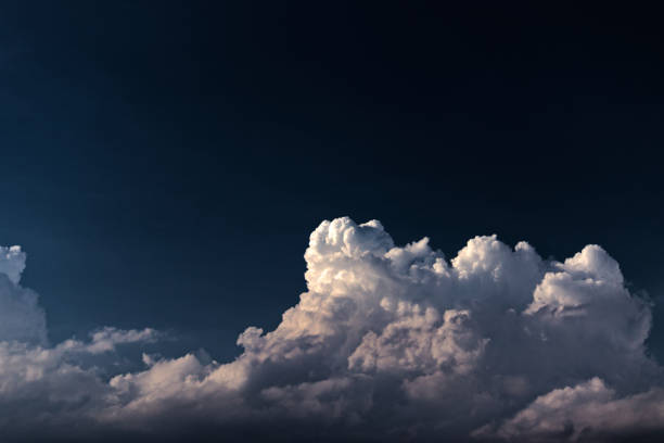 istock top of a sunlit cumulus cloud under a navy blue sky. 1198118385
