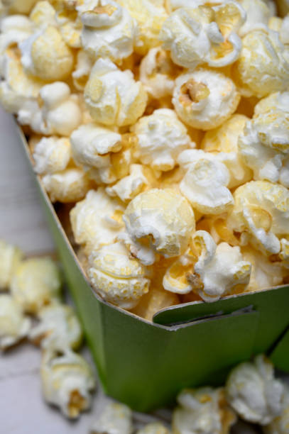 istock Green paper box with sweet popcorn ready to eat 1198118889