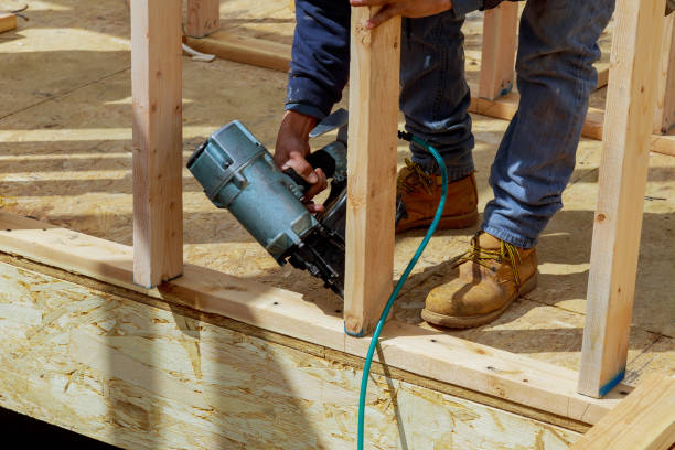 istock Worker nailing timber with air nail gun 1198119472