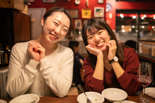 istock Happy young women in restaurant after work 1198120770