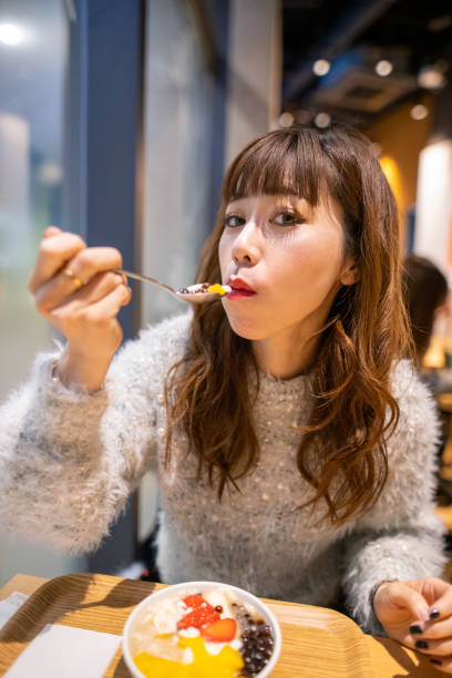 istock Woman eating dessert at cafe 1198121574