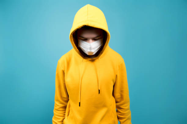 istock a young guy with a medical bandage on his face looks down 1198124947