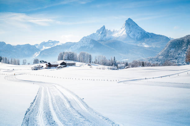 Winter wonderland scenery with trail in the Alps Beautiful winter scenery in the Alps on a cold sunny day with blue sky and clouds bavarian alps photos stock pictures, royalty-free photos & images