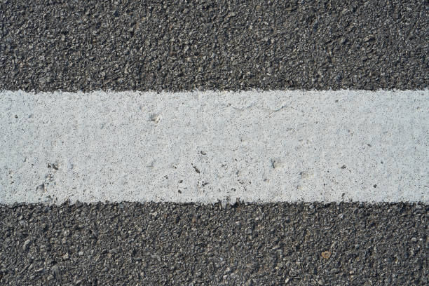 istock Closeup black rough asphalt road 1198128836