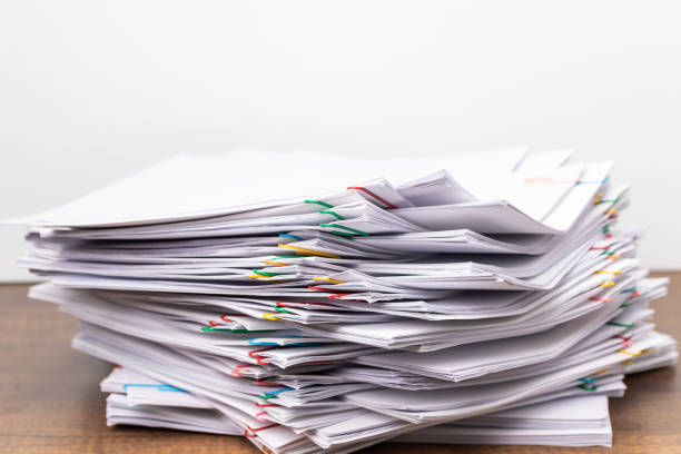 istock Stack overload document report paper with colorful paperclip place 1198131322