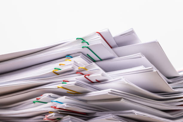istock Stack overload document report paper with colorful paperclip place 1198131331