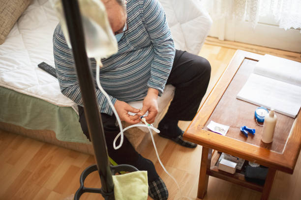 Senior man connecting peritoneal dialysis with catheter at home Senior man connecting peritoneal dialysis with catheter at home nephropathy photos stock pictures, royalty-free photos & images