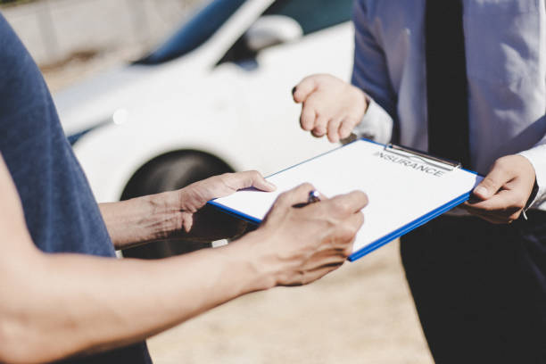 istock Customers and car insurance agents have entered into agreements and signed documents to claim compensation after a car crash, Insurance concept. 1198136947