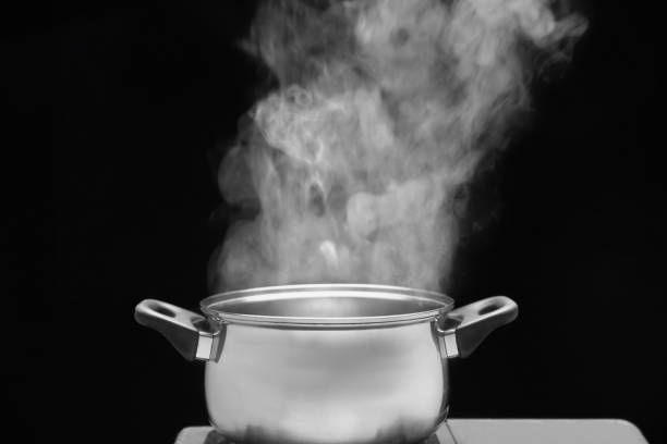 istock steam over cooking pot in kitchen on dark background 1198137243
