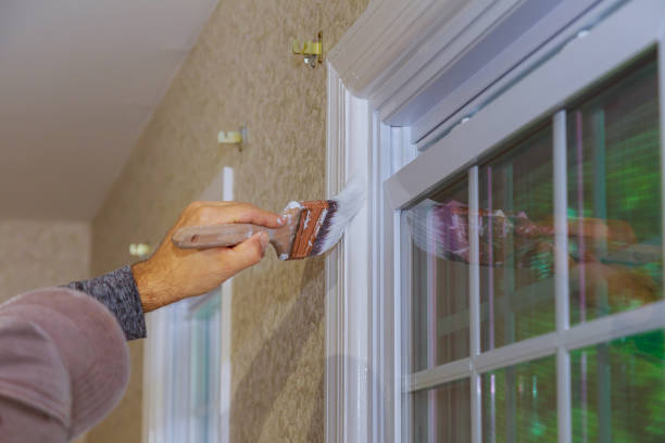 istock Worker painting wooden window frame using paintbrush 1198139174