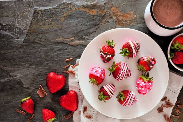 istock Valentines Day chocolate dipped strawberries. Top view table scene against a dark stone background. 1198139271