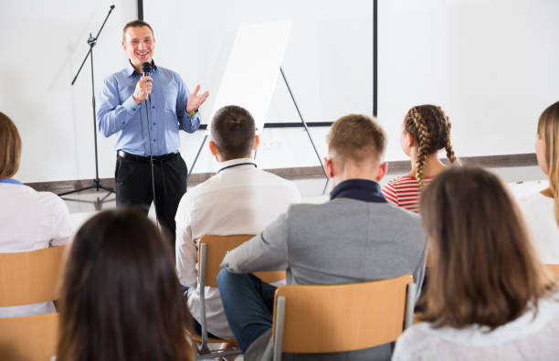 istock Male teacher lecturing to students 1198139648