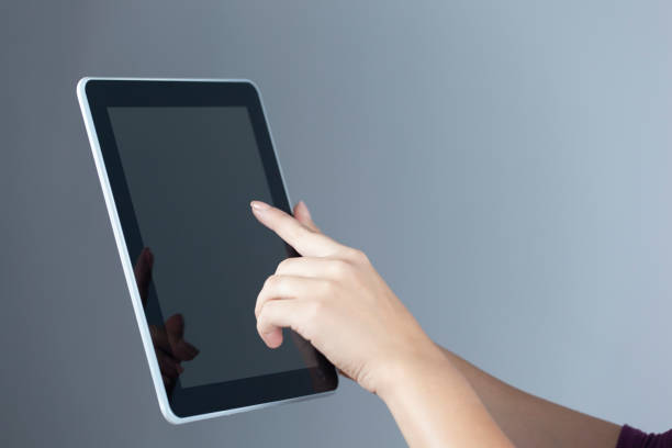 istock young woman hand holding tablet 1198139833