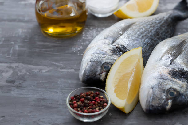 istock raw fish with olive oil and lemon background 1198140508