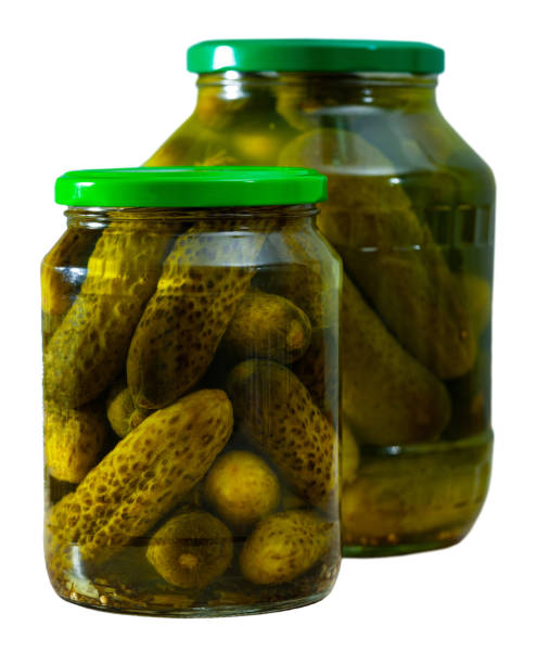 istock Glass jar with pickled cucumbers on a wooden table 1198140799