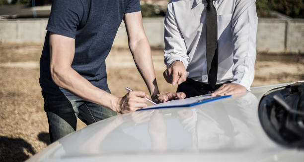 istock Customers and car insurance agents have entered into agreements and signed documents to claim compensation after a car crash, Insurance concept. 1198143766