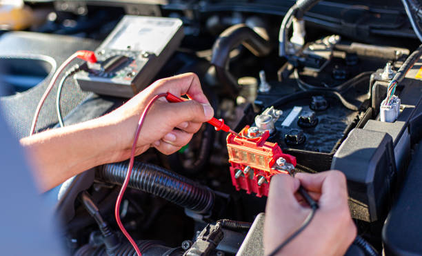 istock Auto repair technician has inspected the condition of the engine using ammeter, Car repair service concept. 1198143821