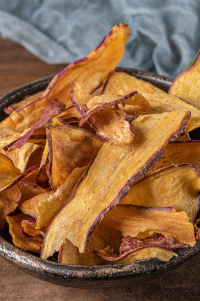 istock Delicious sweet potato chips in bowl, on table. 1198146820