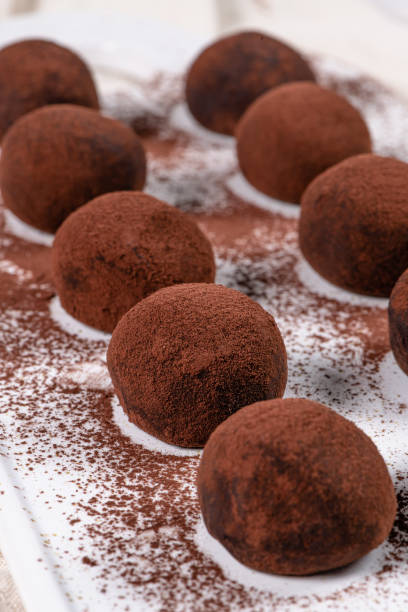 istock Fine chocolate truffles on white ceramic plate. 1198146838