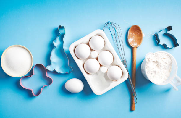 istock Preparation for Easter baking. Ingredients and kitchen items for baking. Kitchen utensils, flour, eggs, sugar. Top view. 1198151097