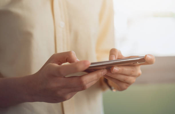 istock Woman hand hold smartphone and playing game on mobile. 1198154766