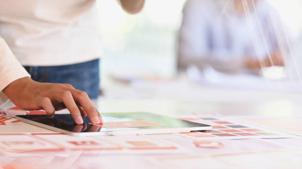 istock Close up hand of UI UX creative team are using on work desk. 1198158176
