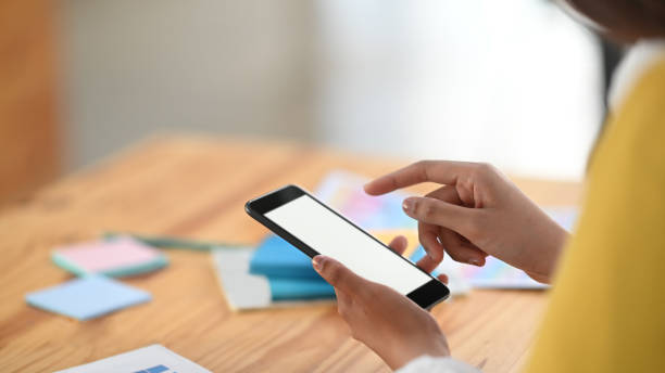 istock Young women are using white blank screen smartphone. 1198158844