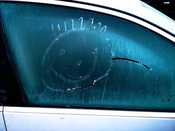 istock Smiley on frozen car window 1198161492