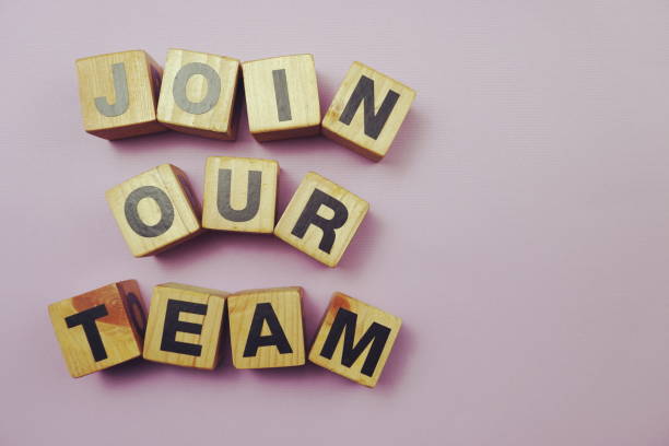 istock Top view Join our team alphabet letters on purple background 1198161654