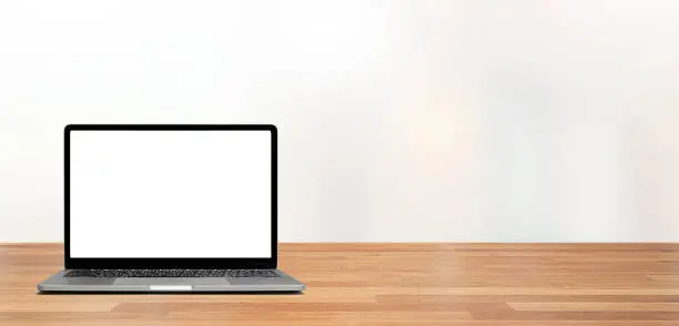 modern laptop in white screen on wooden table against a white clear background