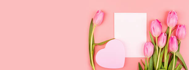 istock View from above tulips and gift box with copy space. Background for womens day, 8 March Valentines day, 14 february. Flat lay style, top view, mockup, template, overhead. Greeting card 1198162315