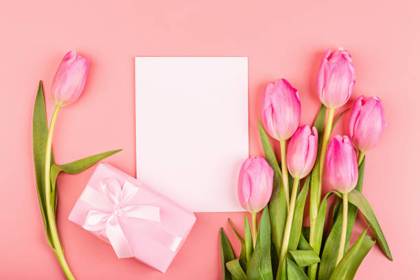 istock View from above tulips and gift box with copy space. Background for womens day, 8 March Valentines day, 14 february. Flat lay style, top view, mockup, template, overhead. Greeting card 1198162474