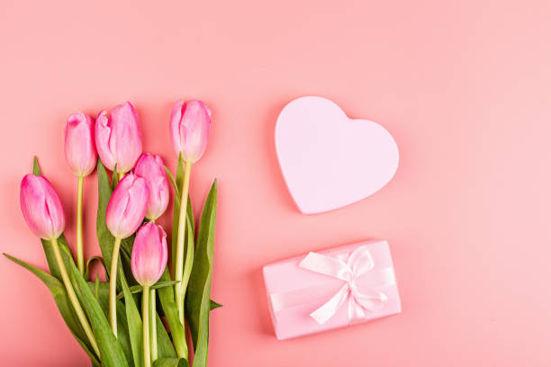 istock View from above tulips and gift box with copy space. Background for womens day, 8 March Valentines day, 14 february. Flat lay style, top view, mockup, template, overhead. Greeting card 1198162603