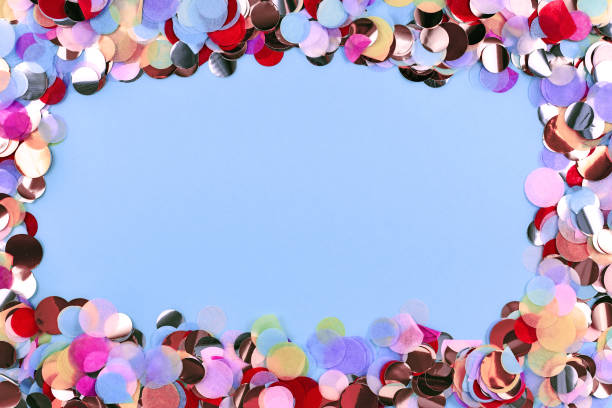 istock Colorful round paper confetti frame around blank copy space on blue background in middle 1198173151