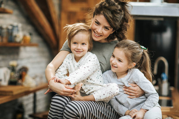 istock Happy single mother spending time with her small kids at home. 1198174579