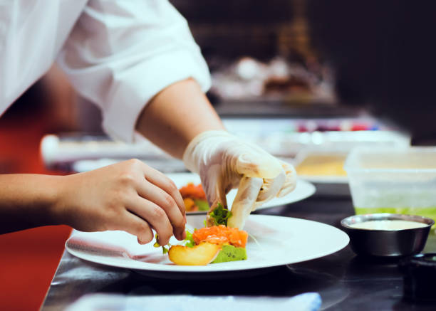 istock Chef cooking, Chef preparing food in the kitchen, Chef decorating dish, closeup 1198174690