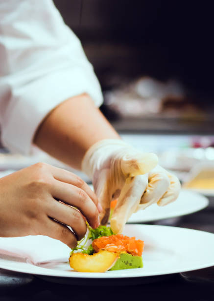 istock Chef cooking, Chef preparing food in the kitchen, Chef decorating dish, closeup 1198174692