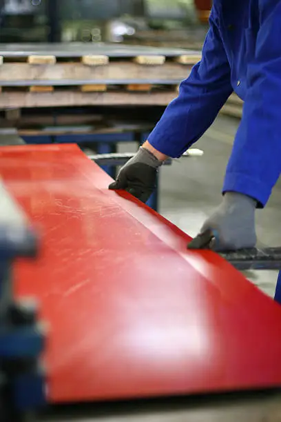 Photo of A set of hands working on a red surface