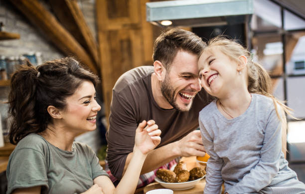 istock Cheerful family having fun while laughing in the kitchen. 1198178114