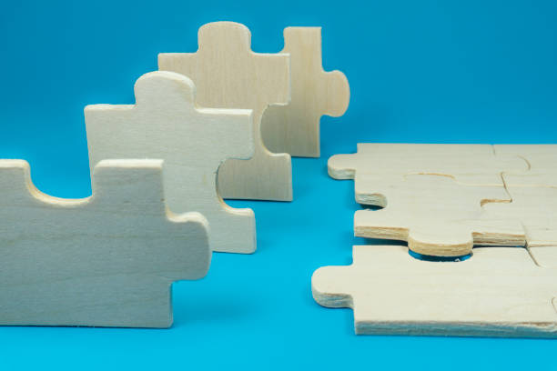 istock Wooden puzzles on blue background 1198179181