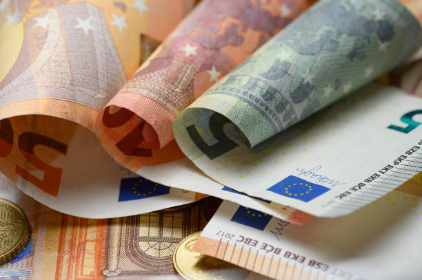 istock Euro banknotes and coins 1198190157