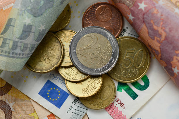istock Euro banknotes and coins 1198190161
