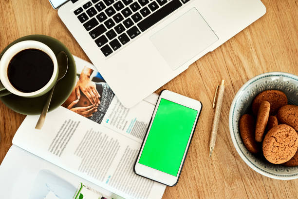 High angle shot of technology and books on a blogger's work desk during the day