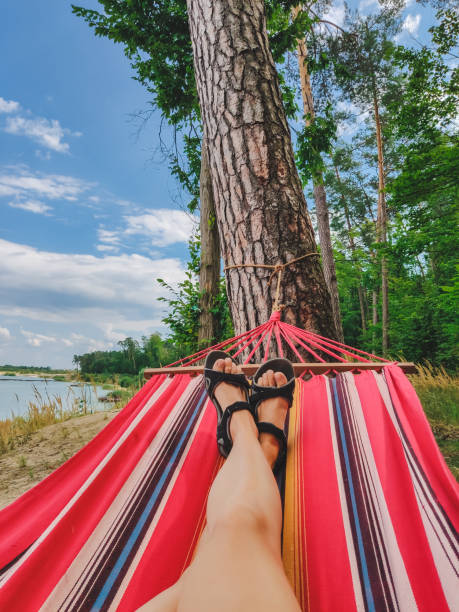 istock woman legs laying at hammock 1198198934