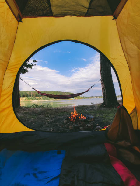 istock view form camping tent on campfire with hammock near lake 1198198956