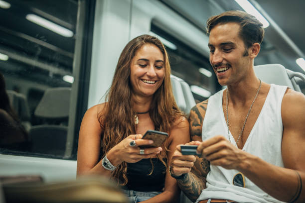 istock Modern couple riding in subway train together 1198200371