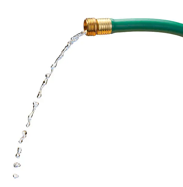  Green rubber hose with a brass nozzle.  Water is pouring from the nozzle.  That image is isolated on a white background and includes a clipping path.  The image is shown from the side, and the water is spilling out turning into drops.