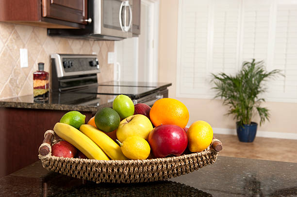 Basket of fresh fruit in modern kitchen  fruit bowl stock pictures, royalty-free photos & images