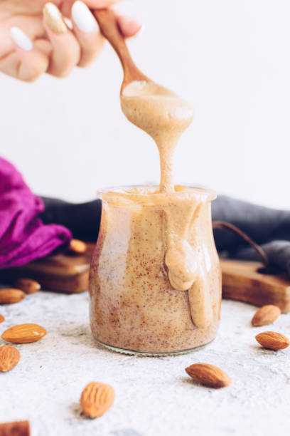 istock Almond nut butter in glass jar 1198204112